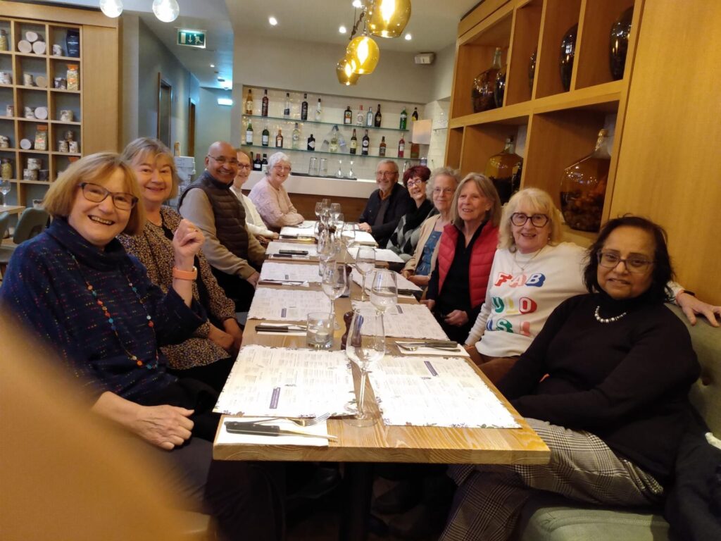 diners sat at a long table in a restaurant